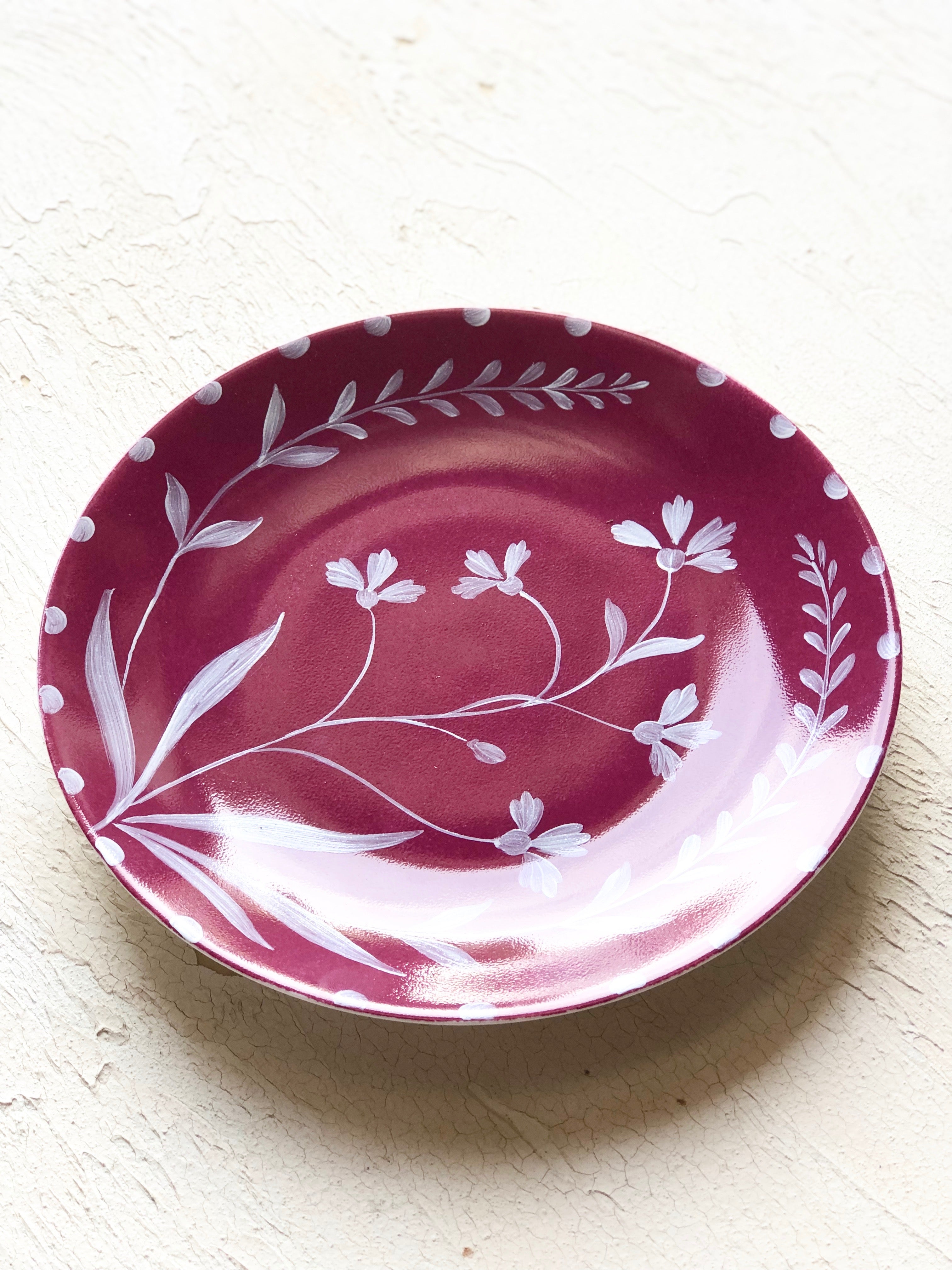 red limoges porecelain dinner plate with hand painted white floral design angled view