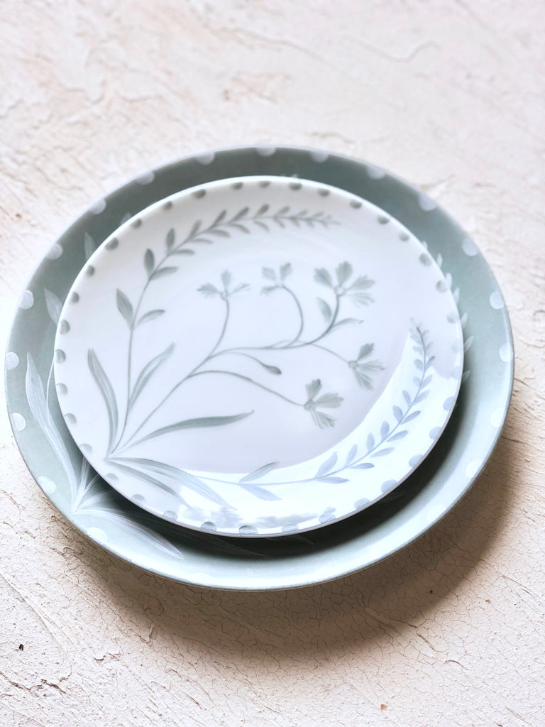 white salad plate with green hand painted floral design 10.5 inch stacked