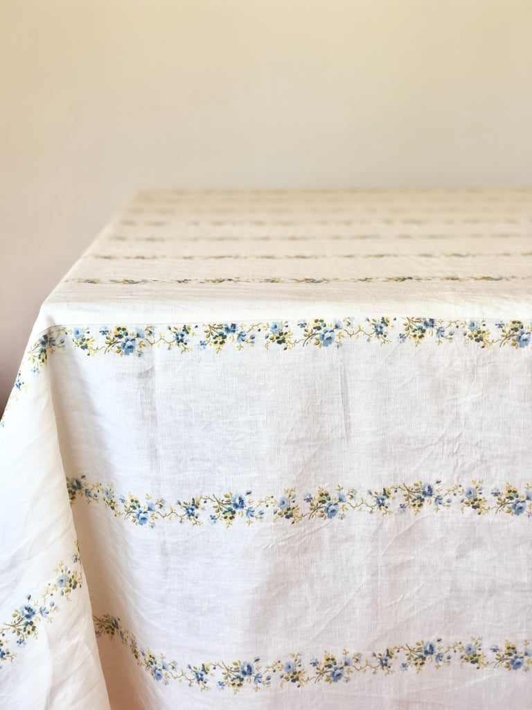 white tablecloth with blue and yellow floral stripe pattern