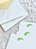 The Printery Fern Gully Note Cards white with green fern and yellow edge 6.25 by 4.5 inches fanned out on table