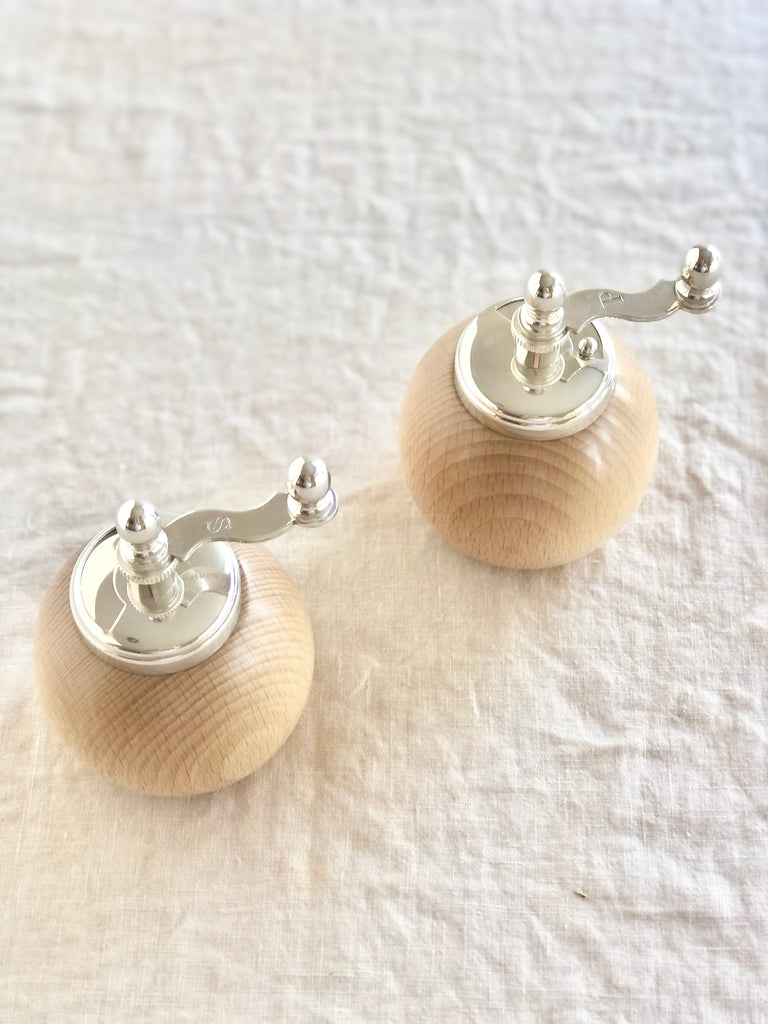 wood salt and pepper grinders with silver handles top view