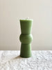 light green totem candle on table