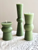 light green totem candle small medium and large on table