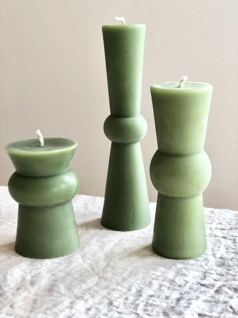 sage green beeswax pillar candle 8.75 inches tall shown in three sizes