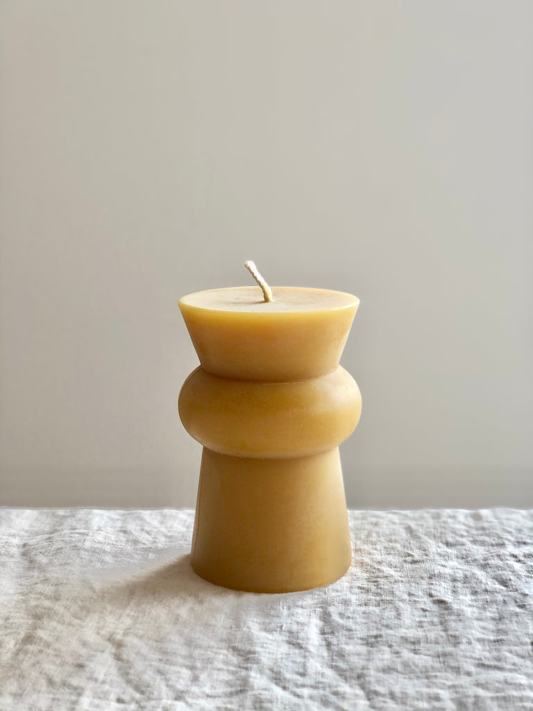 small natural totem candle on a table