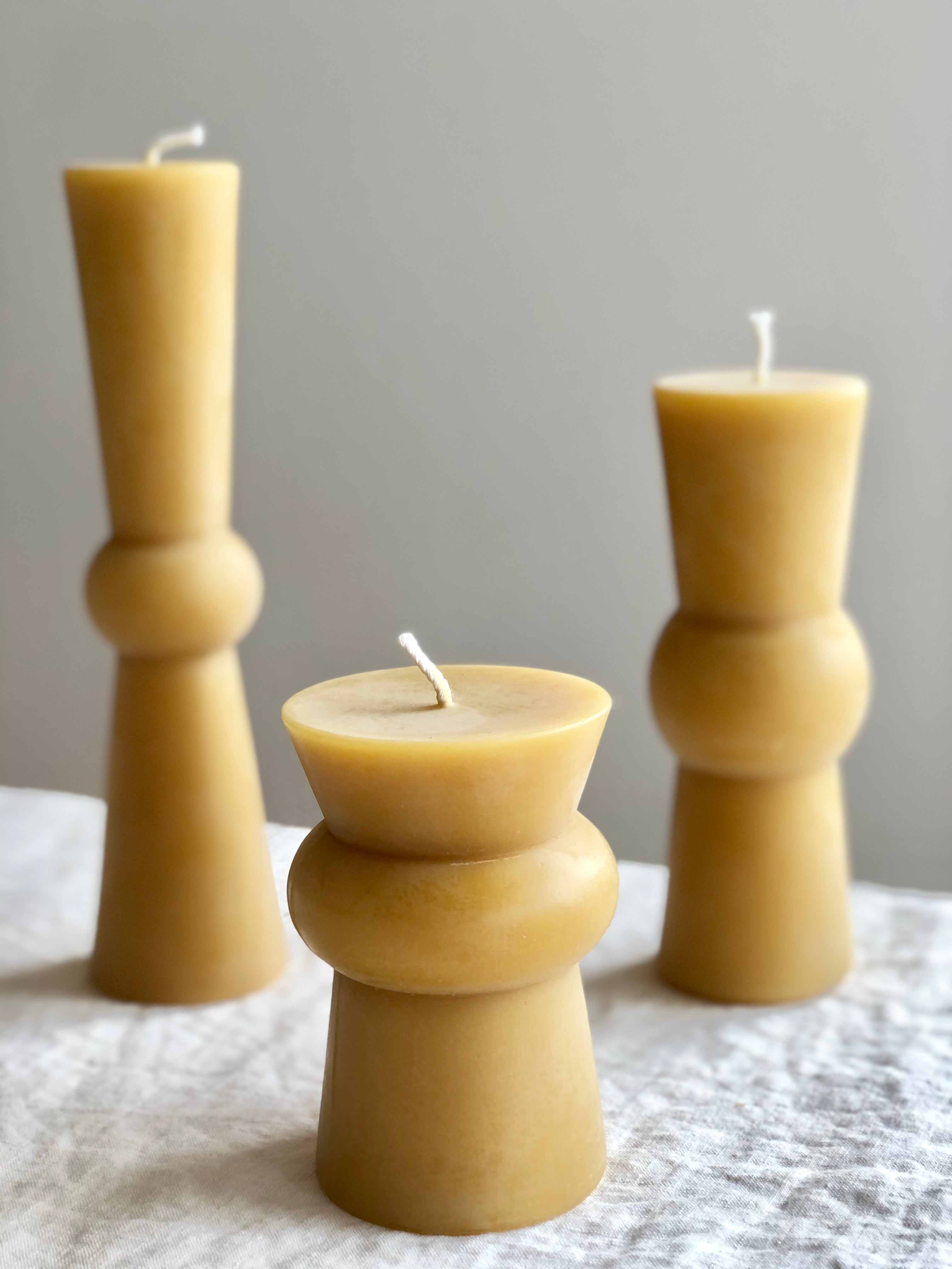 natural pillar candle small medium large arrangement on table