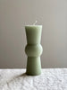 green totem candle medium size on table