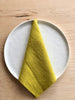 chartreuse linen rolled edge linen napkins with chartreuse edge 18 inches square on white plate