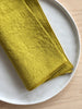 chartreuse linen rolled edge linen napkins with chartreuse edge 18 inches square folded on plate