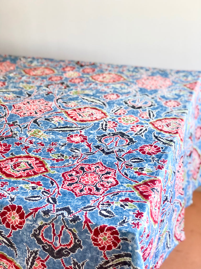 blue linen tablecloth with navy, burgandy and red floral pattern on table
