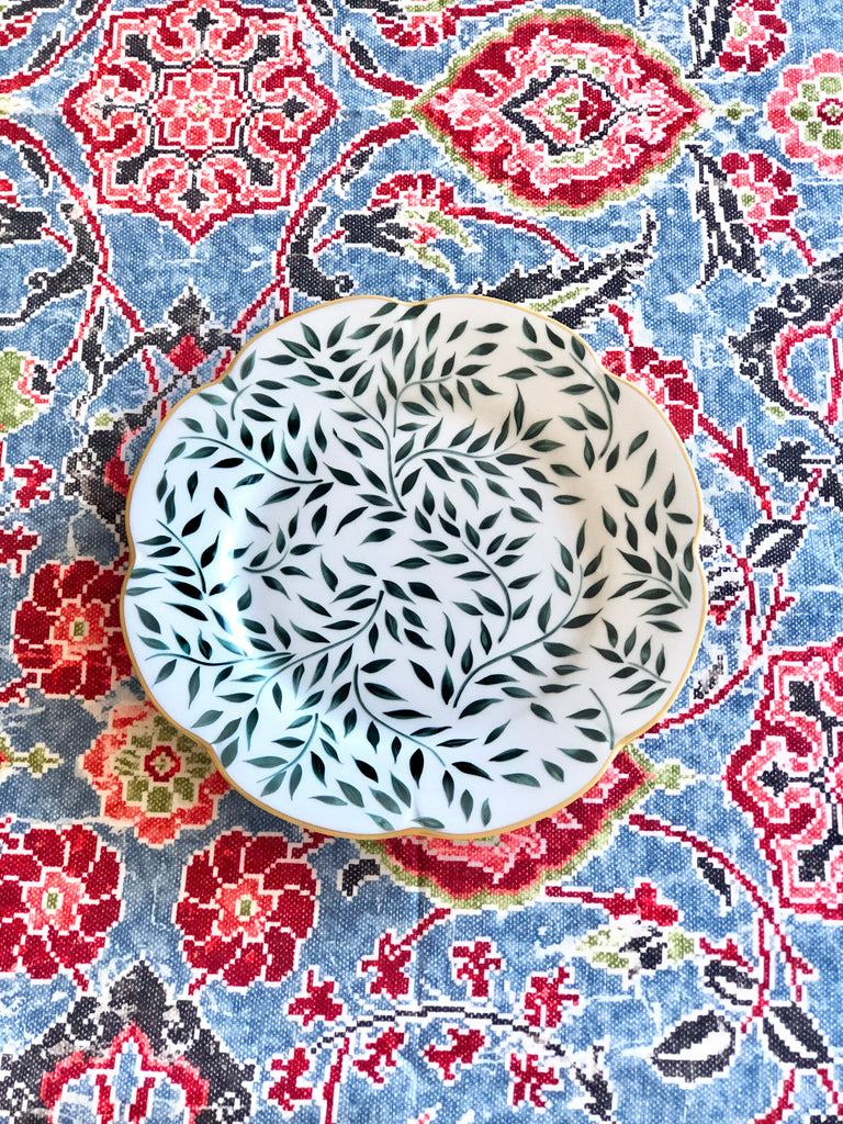 blue linen tablecloth with navy, burgandy and red floral pattern with vine patterned plate