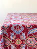 red linen tablecloth with navy, dusty blue and light red floral pattern detail view