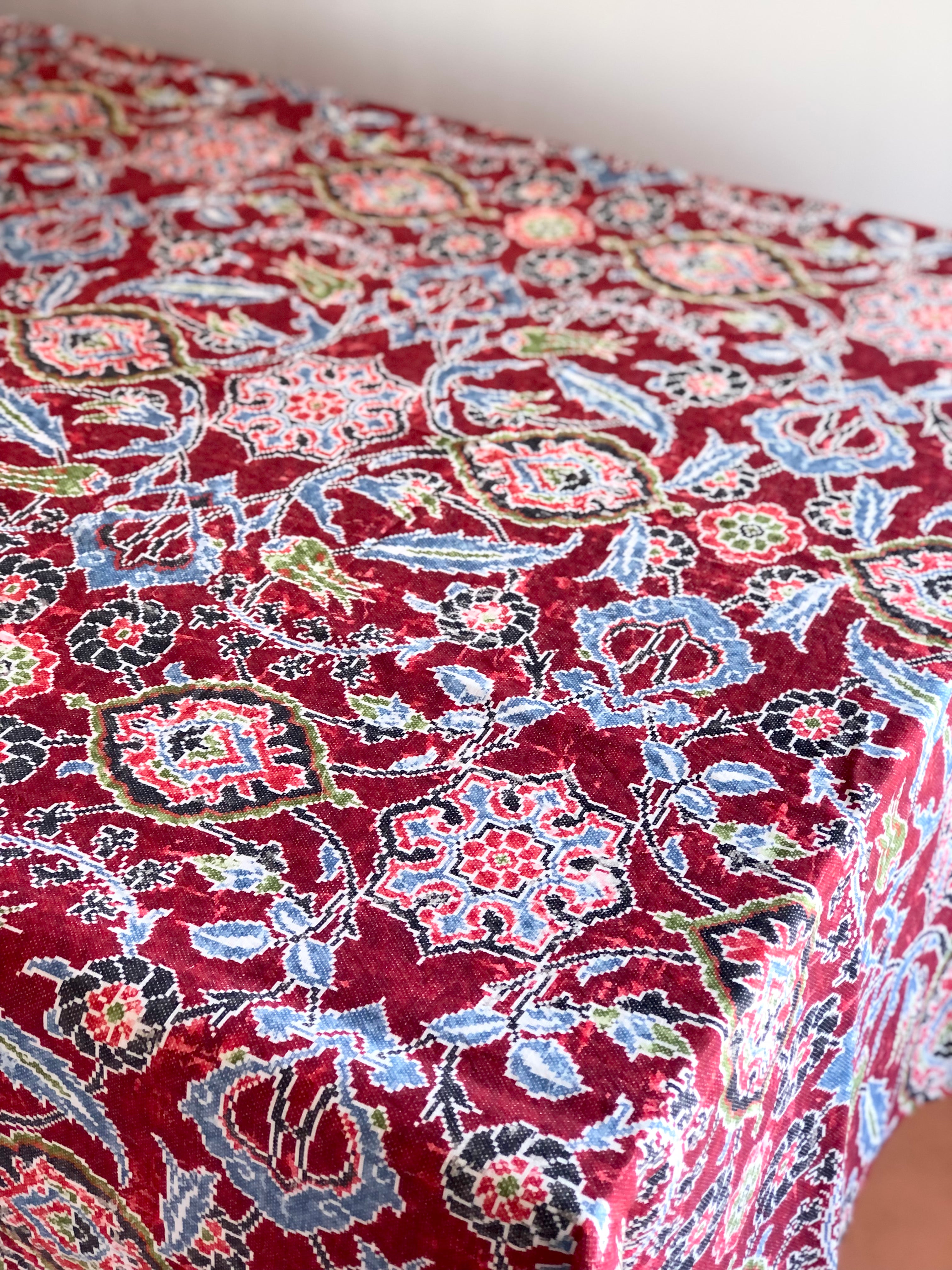 red linen tablecloth with navy, dusty blue and light red floral pattern on table