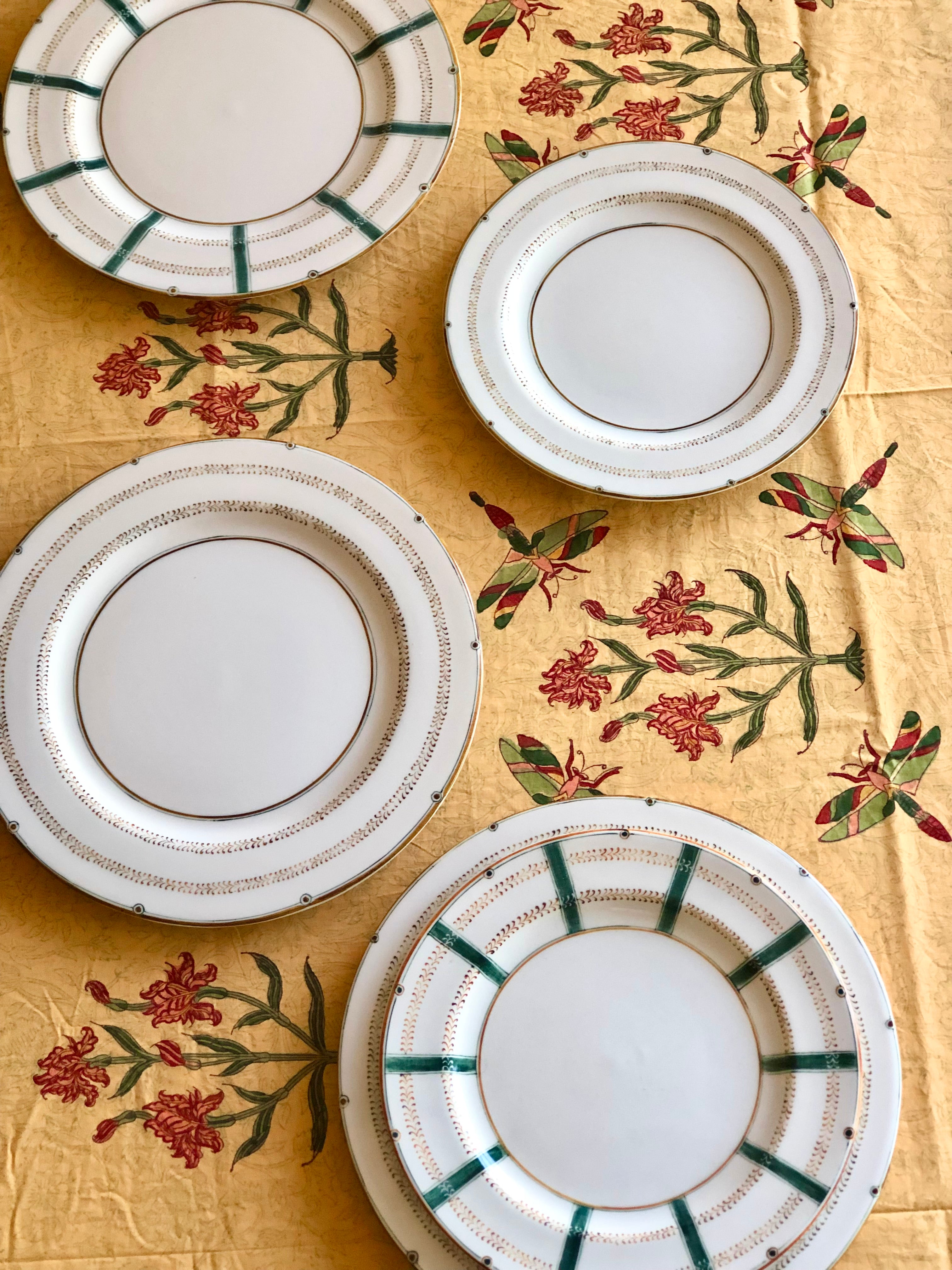 gold tablecloth with green dragonflies red irises and blue gray edge top view