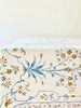 white tablecloth with blue and brown floral pattern