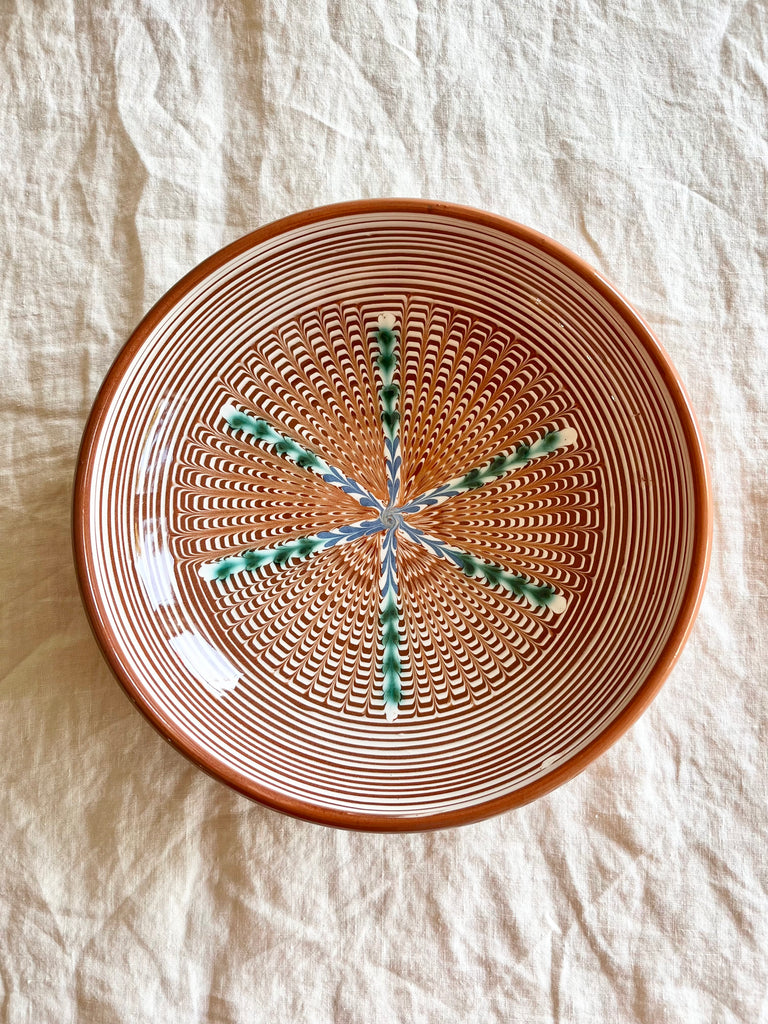 ceramic pasta bowl with radial leaf design in portocale color nested detail view