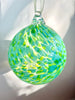 hand blown glass ornament with light and mint green speckle pattern