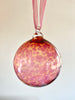 hand blown glass ornament pink ornament hanging on ribbon