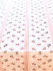 white tablecloth with red pinstripe and red floral pattern detail view