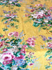 yellow tablecloth with pink white and blue floral pattern detail view
