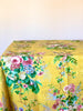 yellow tablecloth with pink white and blue floral pattern  