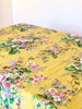 yellow tablecloth with pink white and blue floral pattern angled view