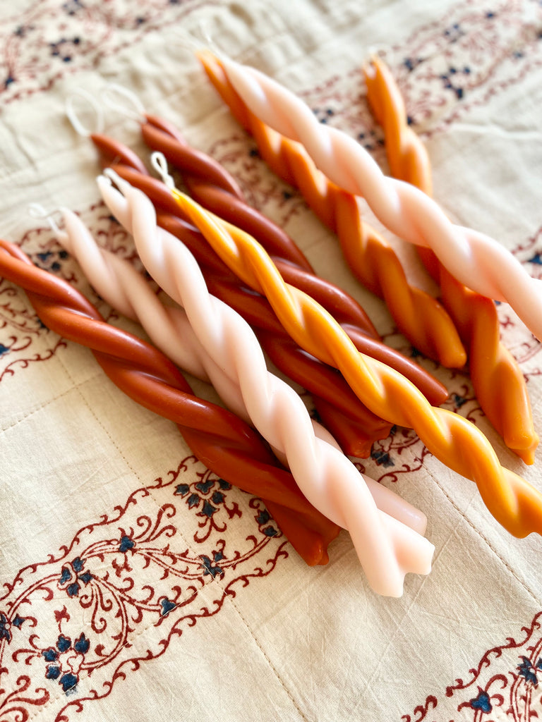 pink twisted taper candles 8.5 inches tall grouped with other color options