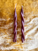 twisted candles by wax atelier choco tapers on gold velvet