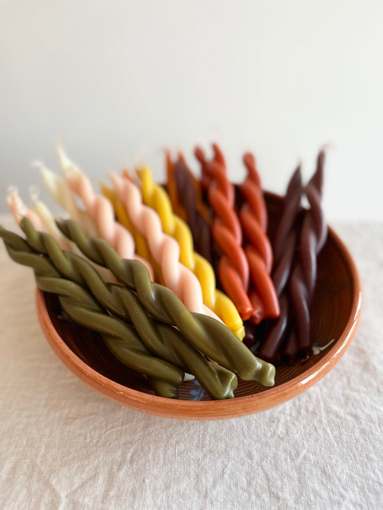 twisted candles by wax atelier multicolor tapers in bowl