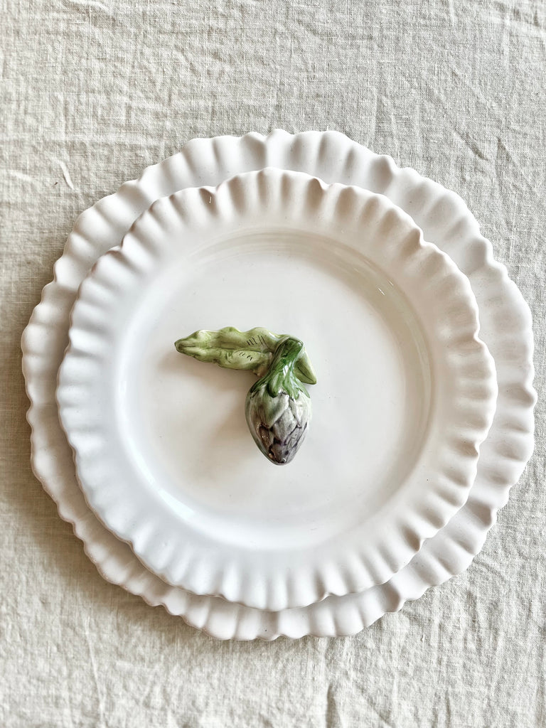 artichoke shaped ceramic knife rest detail on white plate 2.5 inches long