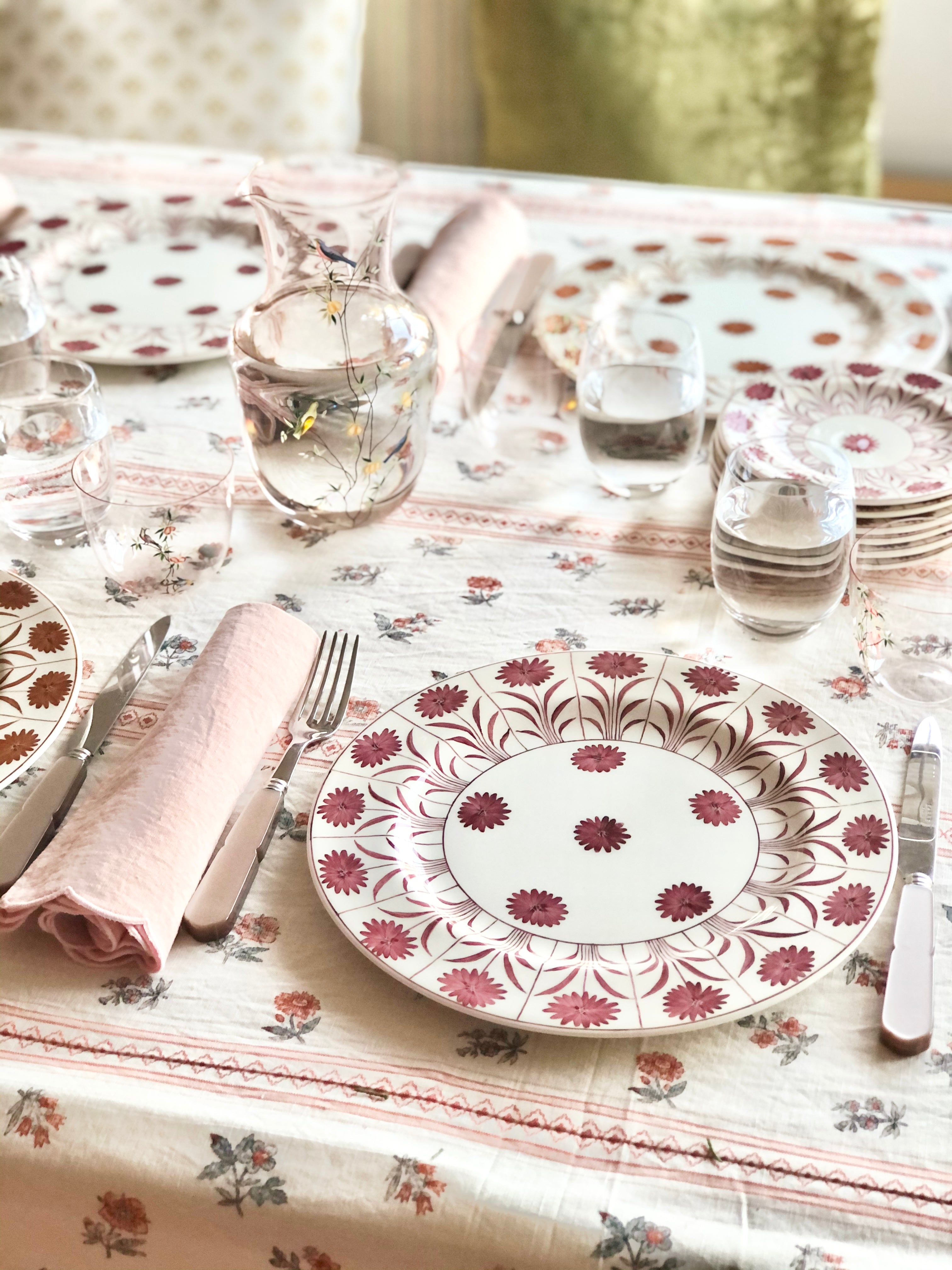 ceramic dinner plate with purple daisy pattern in place setting