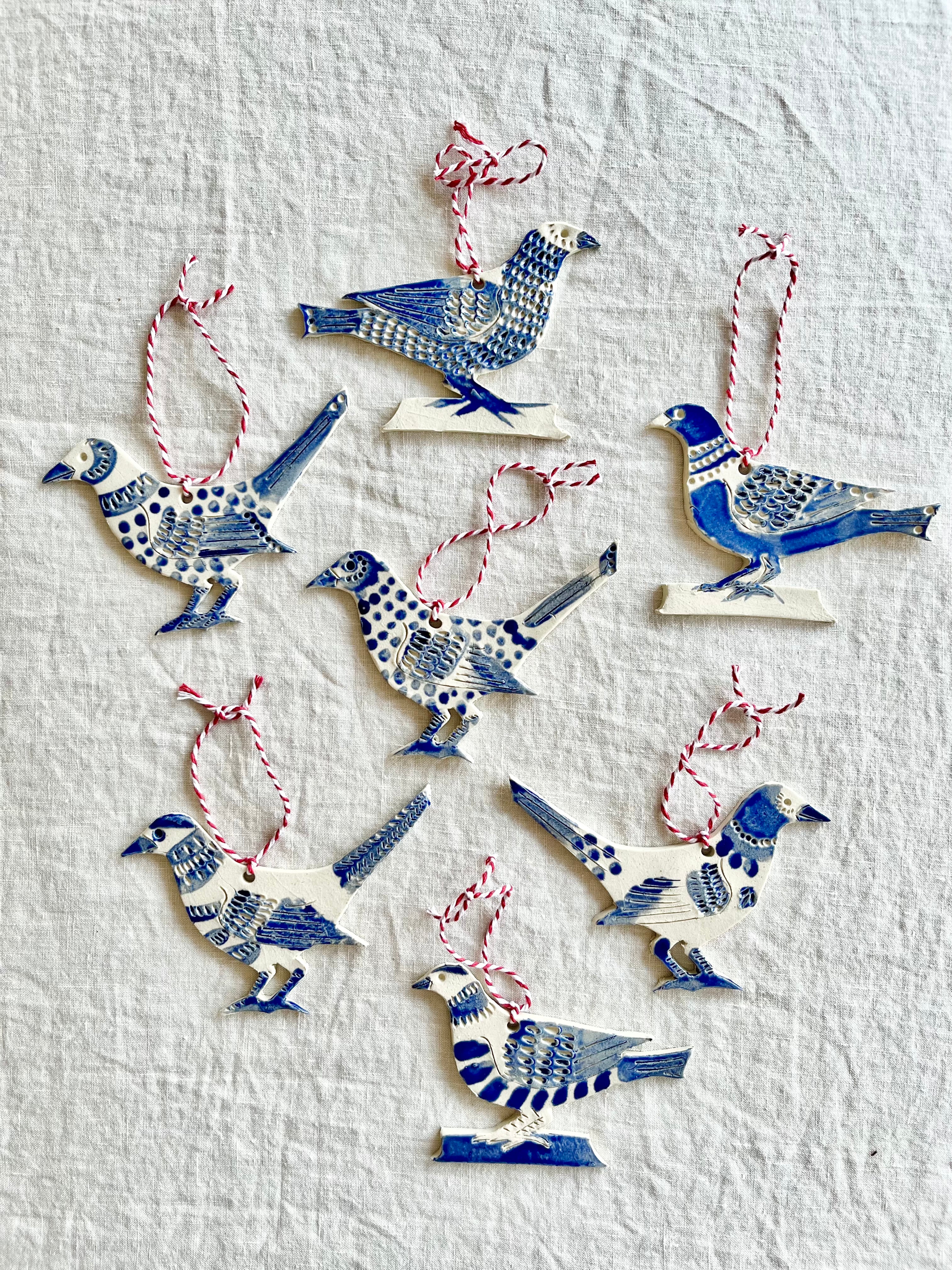 hand painted blue and white bird christmas ornament in group of seven