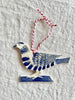hand painted blue and white bird christmas ornament on white table