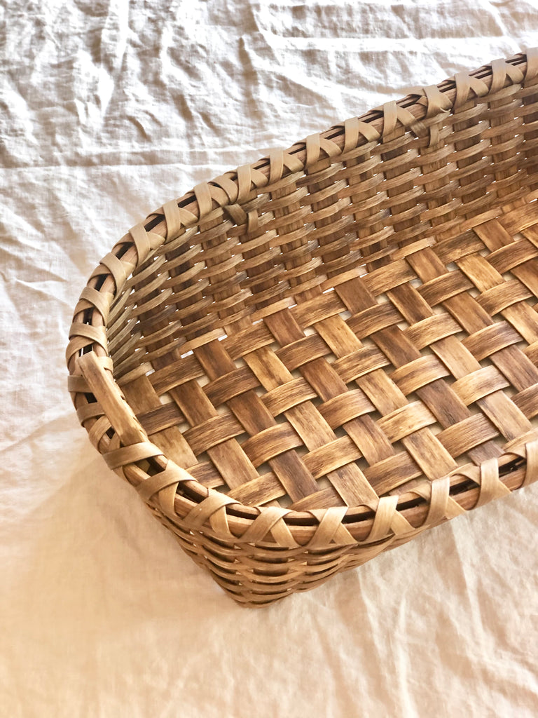 brown oblong hand woven bread basket detail view