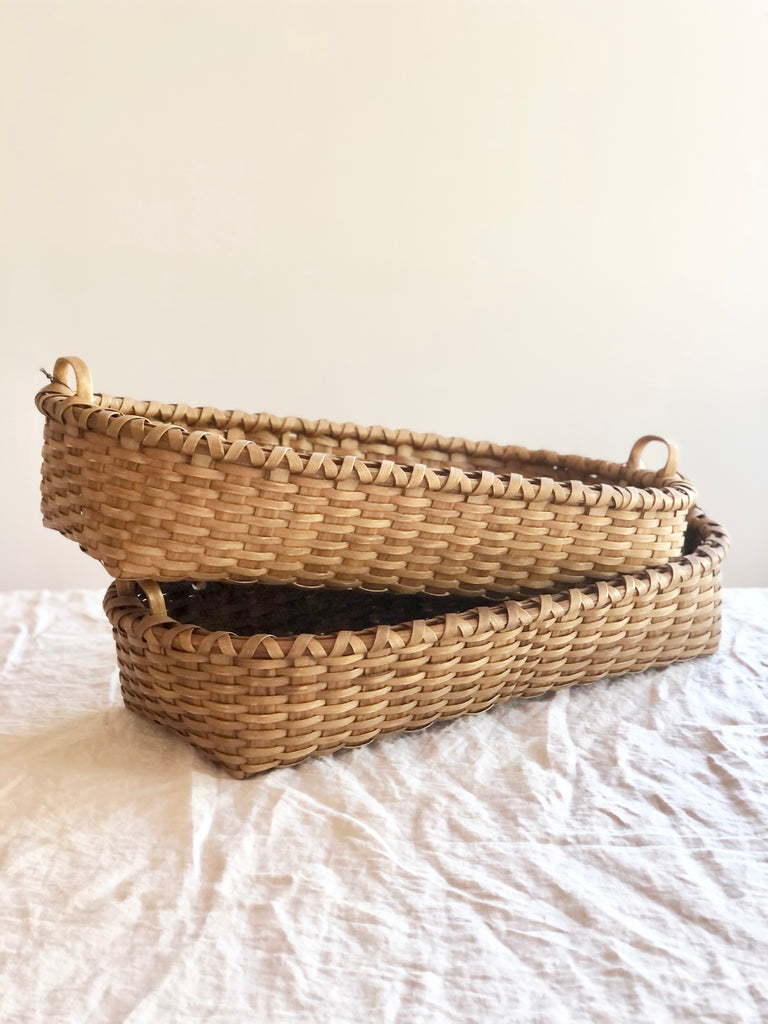brown oblong hand woven bread basket group of two