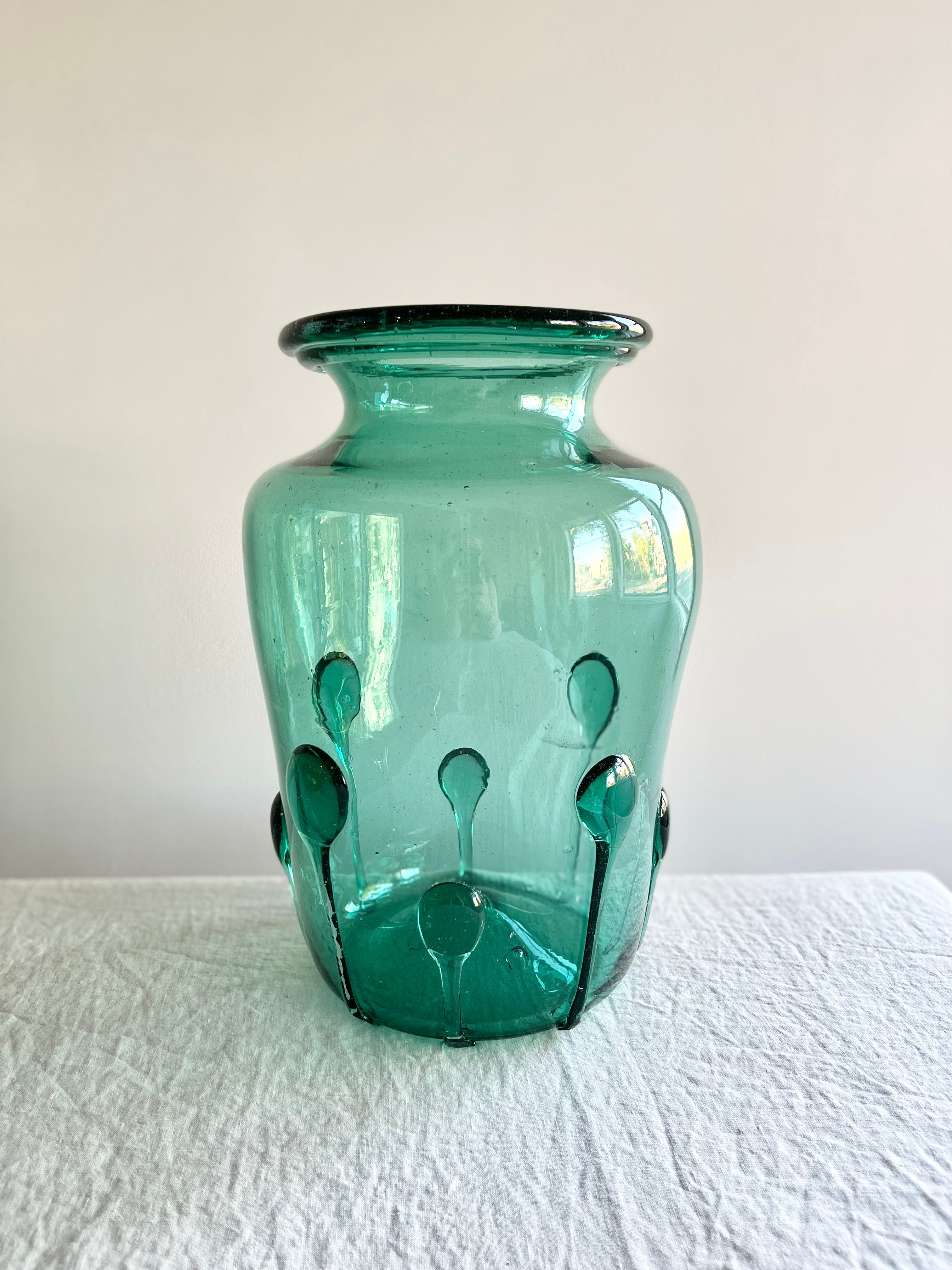 green glass vase with green glass petals on the outside 15 inches tall