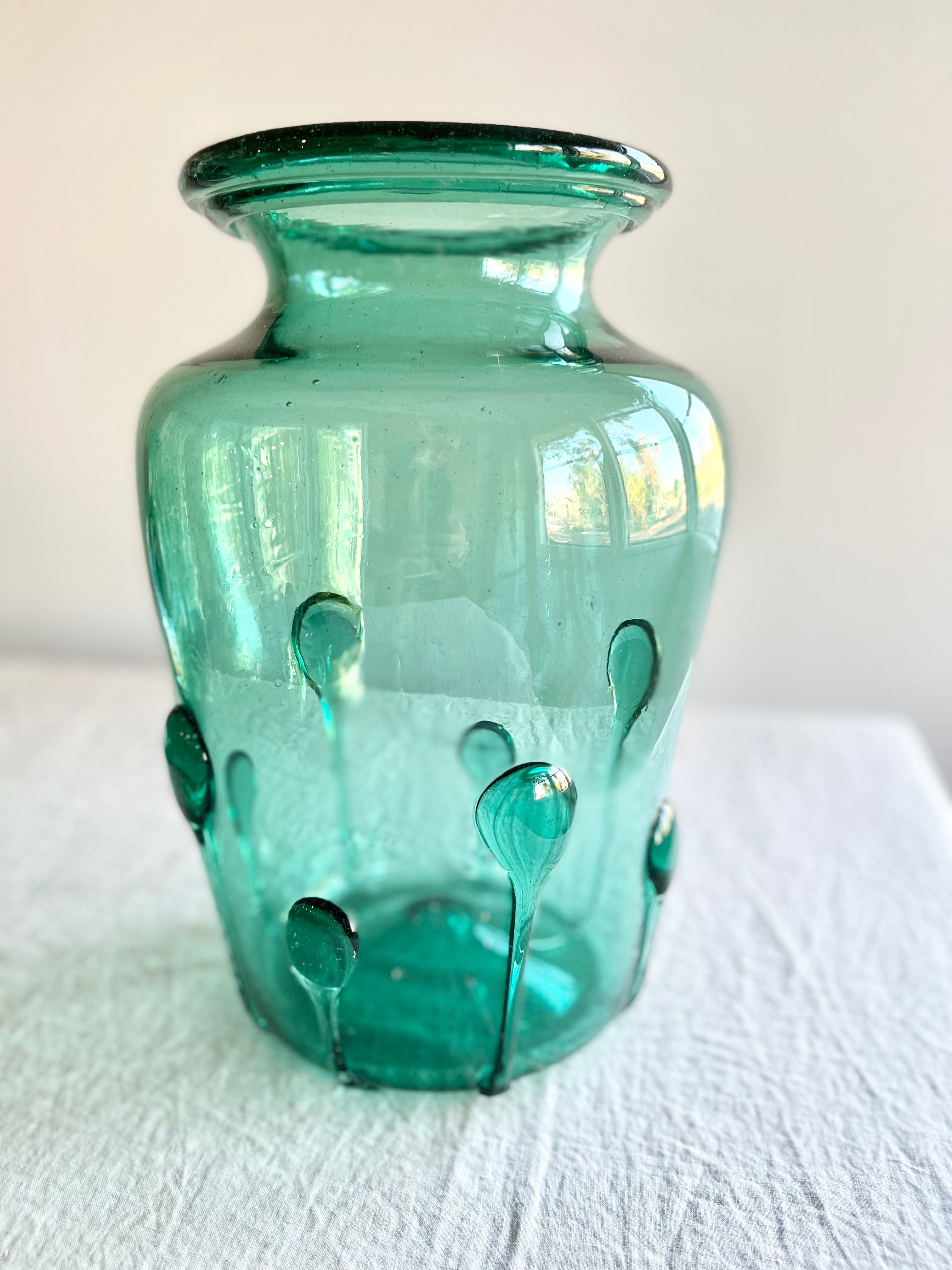 green glass vase with green glass petals on the outside 15 inches tall close up view