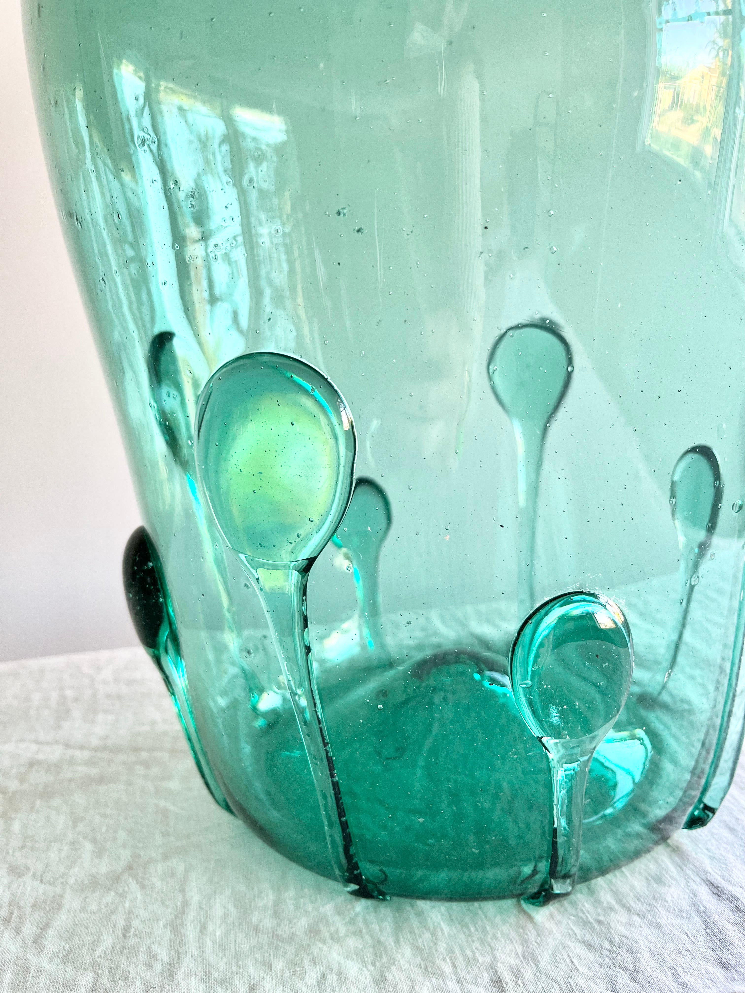 green glass vase with green glass petals on the outside 15 inches tall petal detail view