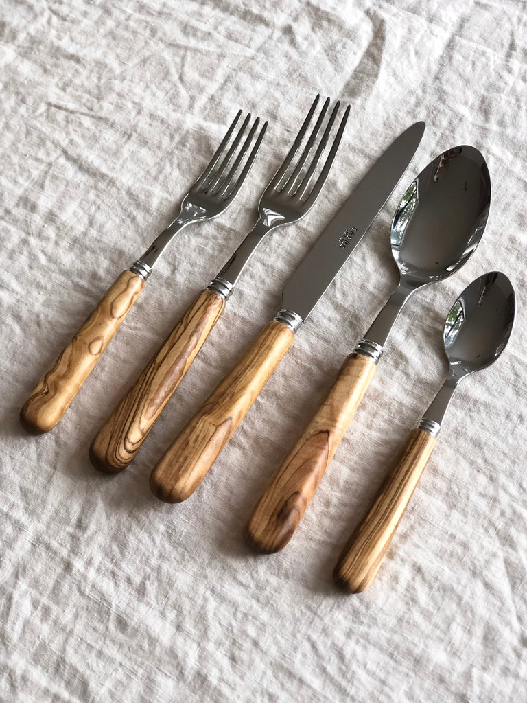 sabre stainless steel flatware set with olive wood handles diagonal view