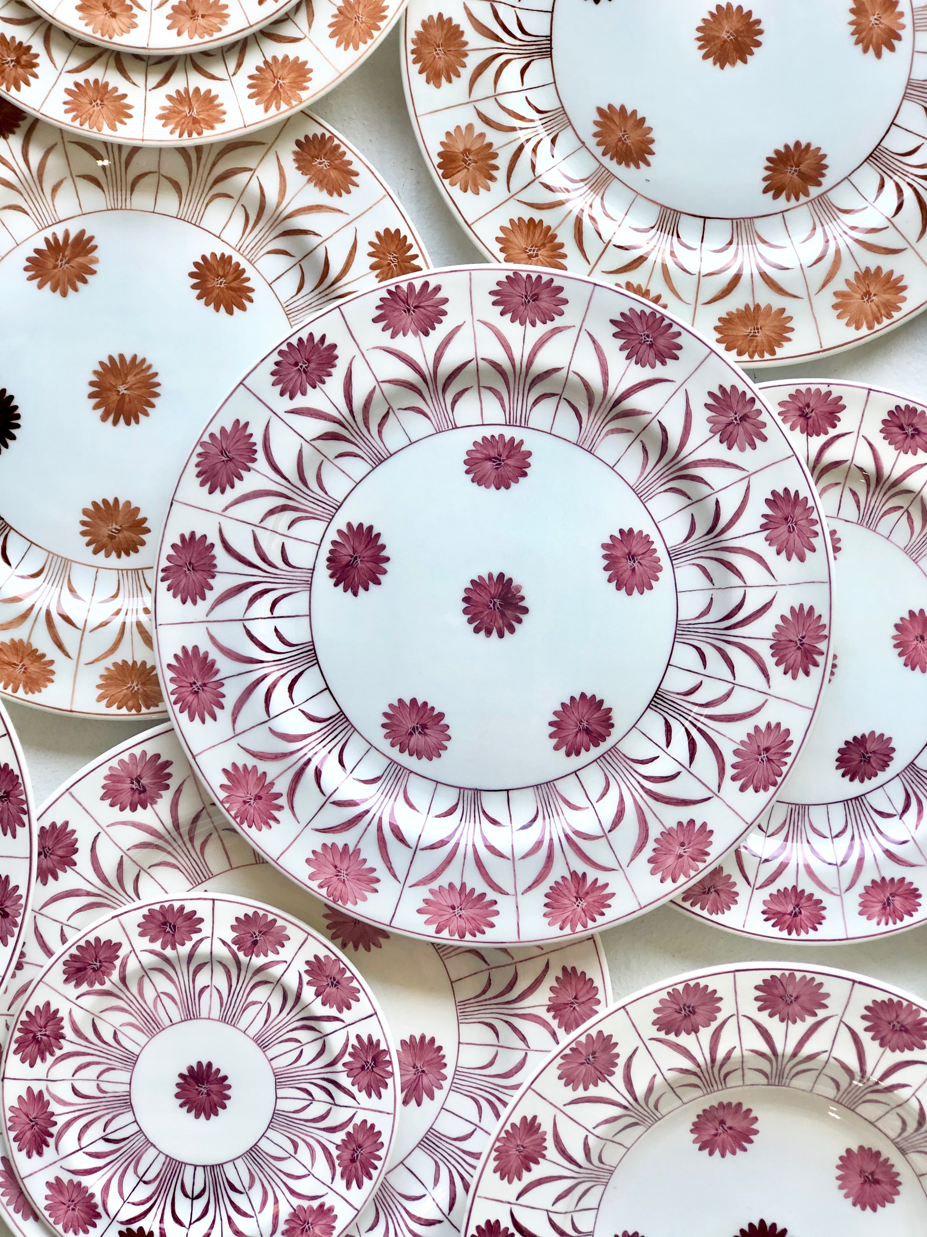 ceramic dinner plate with purple daisy pattern in group