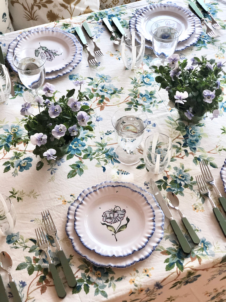 white tablecloth with blue floral pattern with white plates