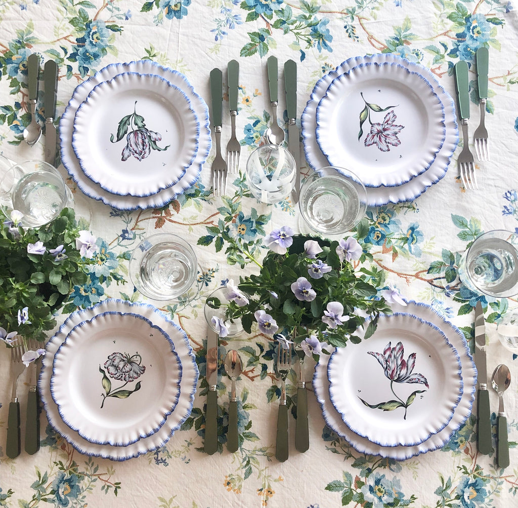 white tablecloth with blue floral pattern with placesetting