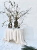 cream linen tablecloth with macrame trim with black vases