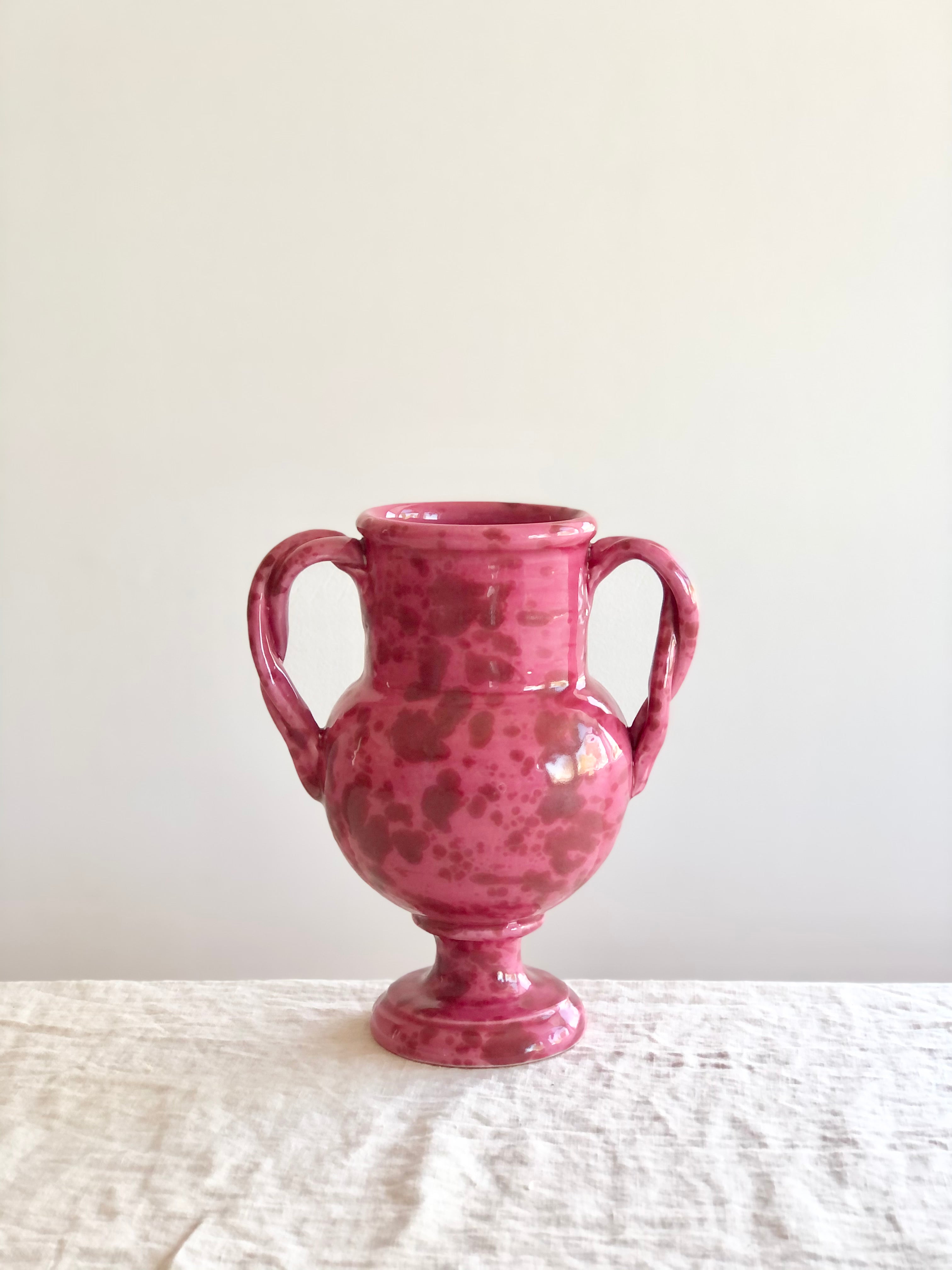 small pink amphora vase with red speckle pattern 8.25 inches tall