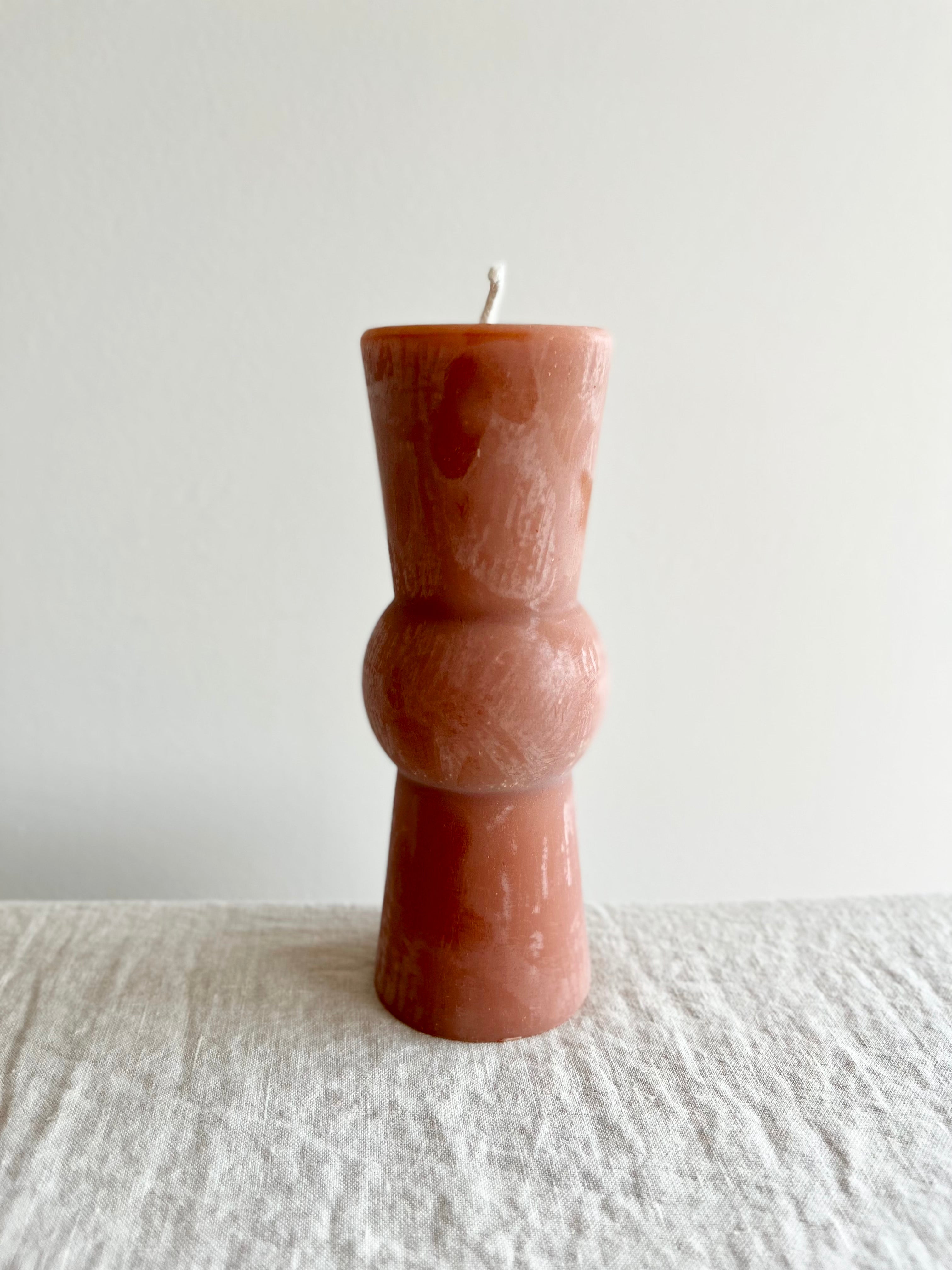 terra totem candle on table