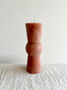 terra totem candle on table