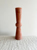tall terra totem candle on a white table