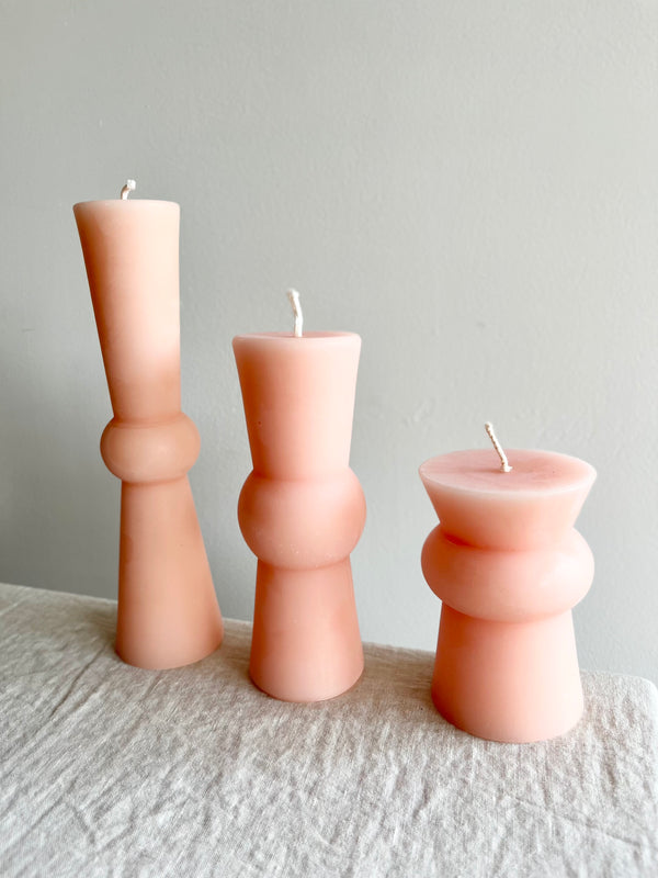 light pink peony totem candles small medium and large lined up on a table