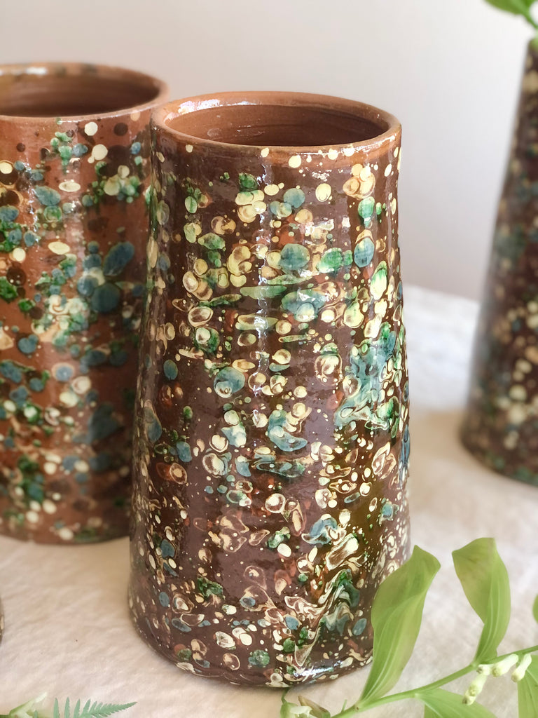 brown cylinder vases with green and cream speckle pattern 8.5 inches tall detail view