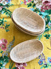 little woven oval baskets on floral table cloth
